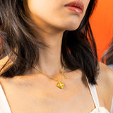 Modern Chinese necklace with a ruyi silhouette, sunray texture, mother of pearl star, and ruyi tag with cubic zirconia for good luck. Comes in 14k gold vermeil.