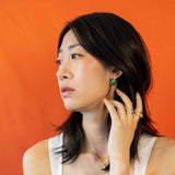 Chinese woman wearing modern style jade aesthetic hoop earrings.