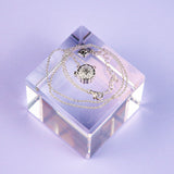 Mini Mooncake Locket is a modern Chinese jewelry piece made with sterling silver and gold plating.