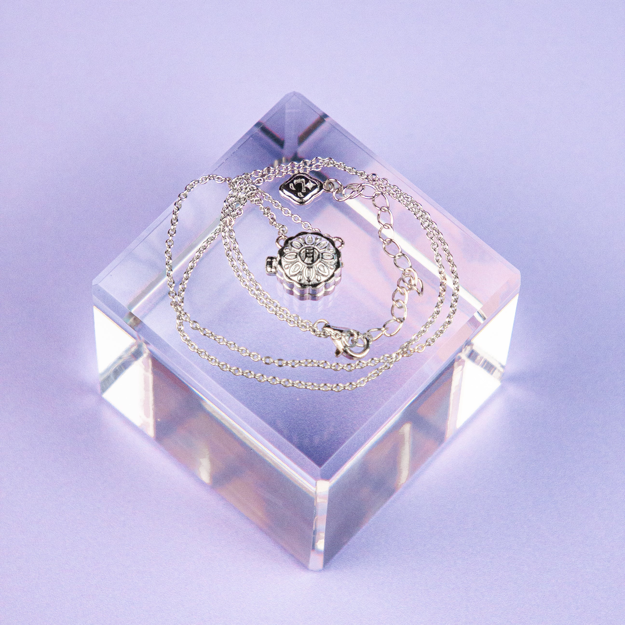Mini Mooncake Locket is a modern Chinese jewelry piece made with sterling silver and gold plating.