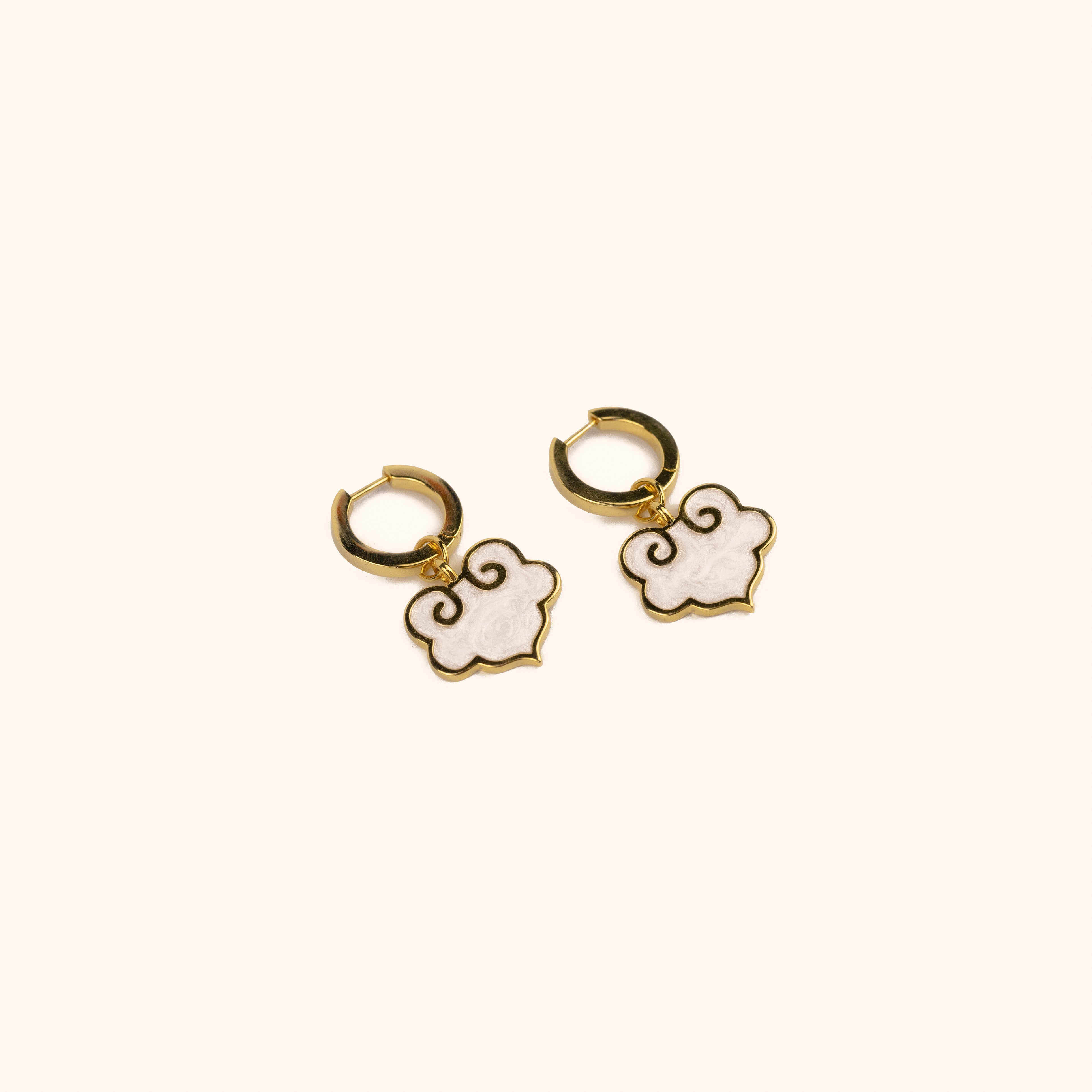 Ruyi earrings with ruyi shaped charms outlined in gold and filled with pearlescent white enamel.
