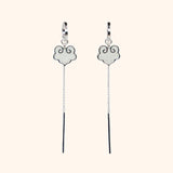 Ruyi earrings with ruyi shaped charms outlined in silver and filled with pearlescent white enamel.