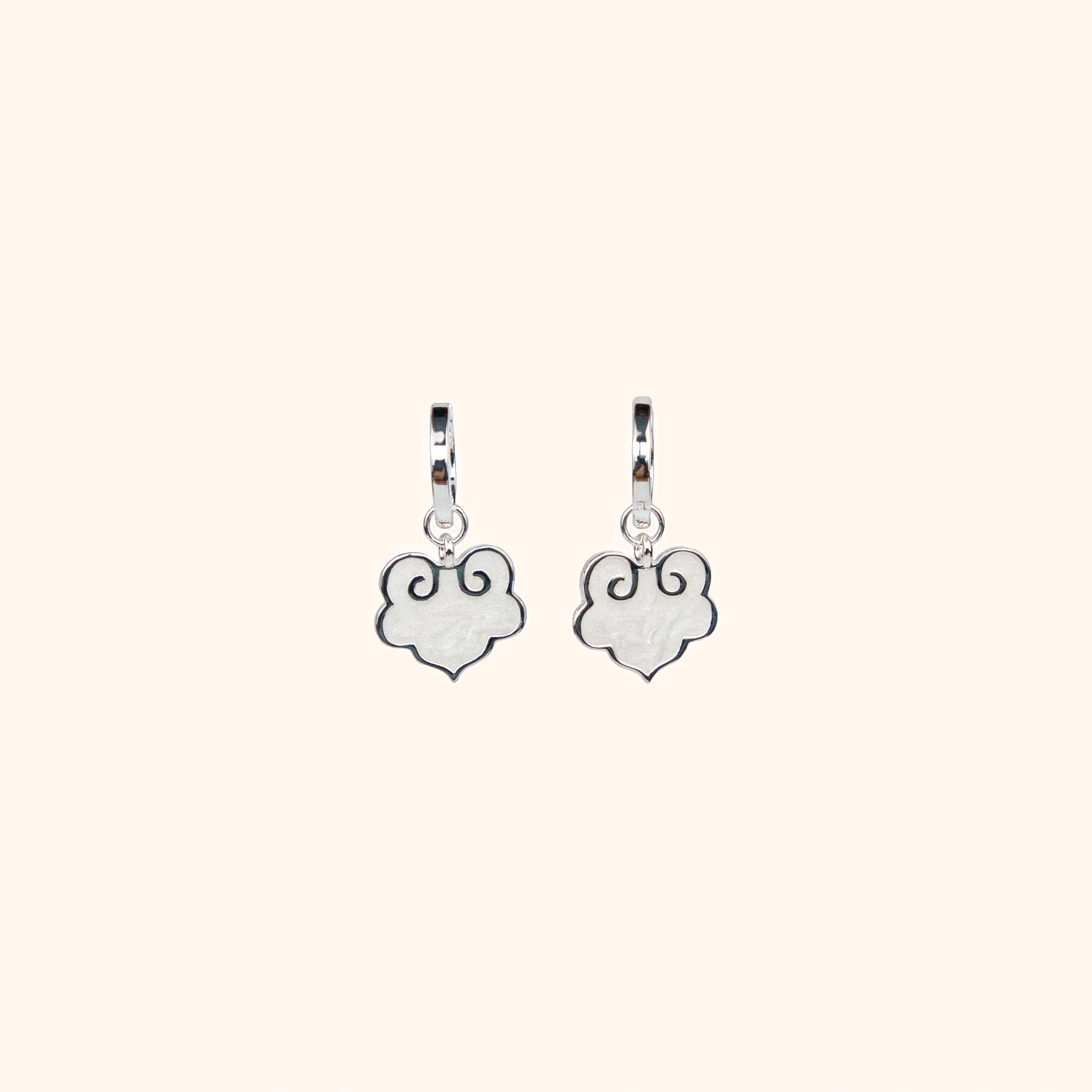 Ruyi earrings with ruyi shaped charms outlined in silver and filled with pearlescent white enamel.
