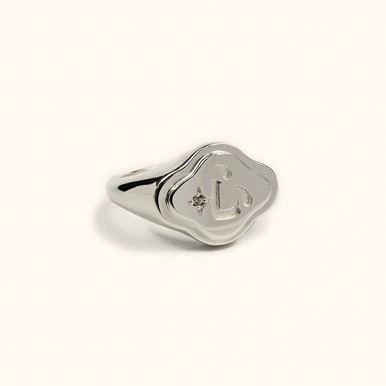 Modern Chinese silver signet ring with ruyi shape and the Chinese 心 character engraved in the center.