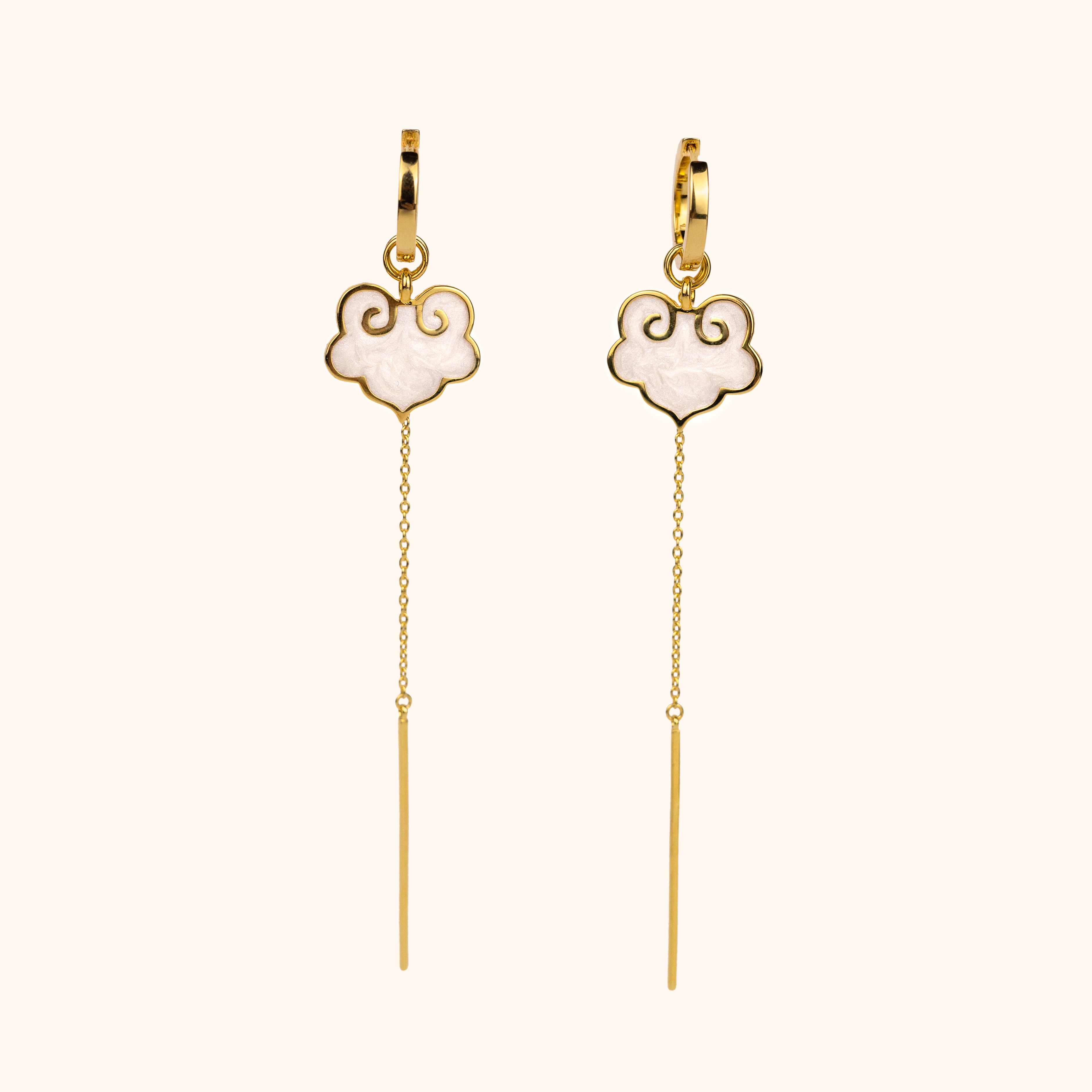 Ruyi earrings with ruyi shaped charms outlined in gold and filled with pearlescent white enamel. 